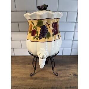 Celebrating Home Stoneware Collection Beverage Dispenser on Wrought Iron stand.